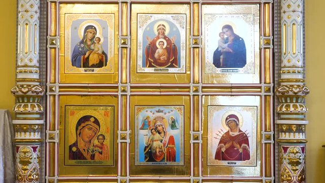 Detailed icons in Russian Church. Stock footage. Close-up beautiful images of angels and sacred faces on icons inside Church