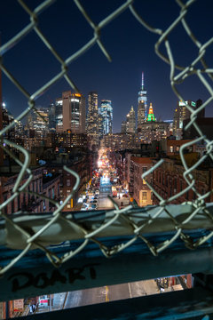 Image of New York City Night Cityscape with City View through a broken fence to see urban metropolis at night