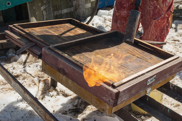 Beekeepers prepare hives for the new season. Cleaning the pallets of hives.