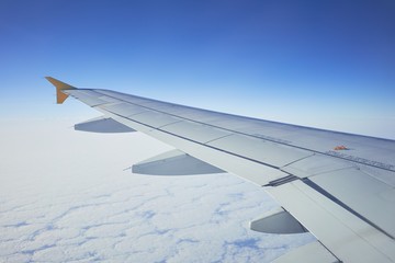 Fototapeta na wymiar Cloudscape from window airplane, landscape of wing plane on a cloudy sky