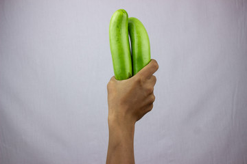 Green Eggplant held by hand with white background