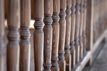 Fototapeta premium A row of balusters of a wooden veranda.