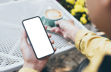 cell phone Mockup image blank white screen.man hand holding texting using mobile on desk at coffee shop.background empty space for advertise text.people contact marketing business,technology