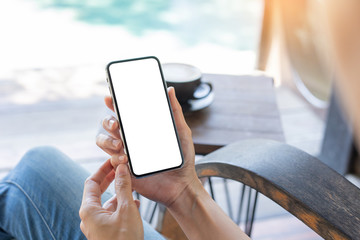 cell phone Mockup image blank white screen.woman hand holding texting using mobile on desk at coffee shop.background empty space for advertise text.people contact marketing business,technology