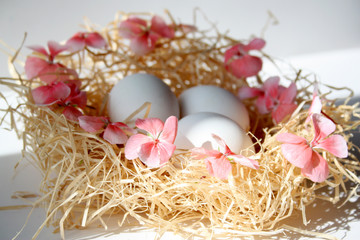 Easter, decor for the holiday. Chicken eggs in the nest.