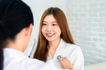 Female doctor talking to patient.Doctor and patient discussing something while sitting at the table . Medicine and health care concept. Doctor and patient