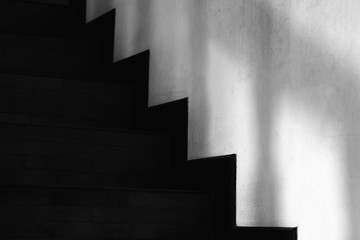Abstracted light and shadow on the wall next to the stairs.