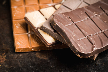 Chocolate bar on the rustic background. Selective focus. Shallow depth of field.