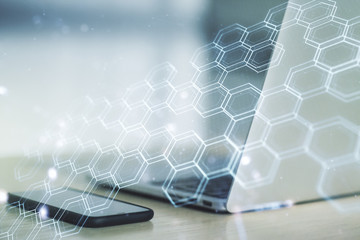 Creative concept of wireless technology with hexagon hologram on modern laptop background. Big data and database concept. Multiexposure
