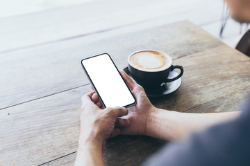 cell phone Mockup image blank white screen.man hand holding texting using mobile on desk at coffee shop.background empty space for advertise text.people contact marketing business,technology