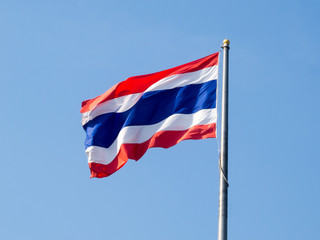 Thai flag on a blue sky background.