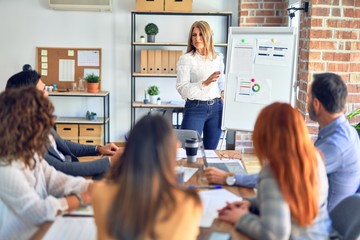 Group of business workers working together in a meeting. One of them making presentation to...