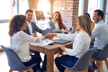 Group of business workers smiling happy and confident. Working together with smile on face shaking hands at the office