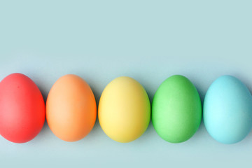 Preparation for the Easter holiday. Eggs and Easter decor on a bright background