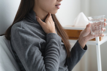 Seasonal disease symptom concept. Bad healthy woman touching her neck and feeling sore throat from...