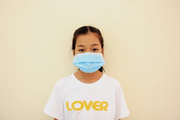 Children girl is protective surgical mask on their face and prevent Air pollution pm2.5 concept and Coronavirus Covid-19.