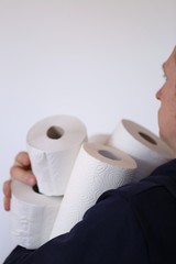 Buying toilet paper. Deficit. Essential product. Toilet paper rolls set in the hands of men on a white background.Coronavirus concept.Hygiene and health concept.