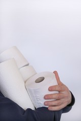Buying toilet paper. Deficit. Essential product. Toilet paper rolls set in the hands  on a white background.Coronavirus concept.Hygiene and health concept.