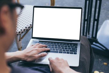 computer mockup image blank screen with white background for advertising text,hand woman using laptop contact business search information on desk at coffee shop.marketing and creative design