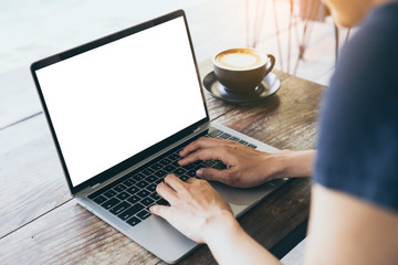 computer mockup image blank screen with white background for advertising text,hand woman using laptop contact business search information on desk at coffee shop.marketing and creative design