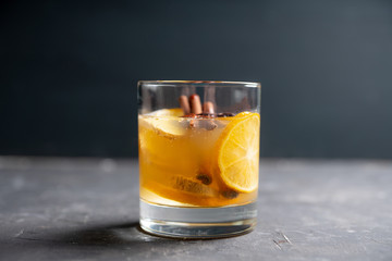 Healthy hot beverage with lemon, ginger and spices for protection in flu season. Selective focus. Shallow depth of field.