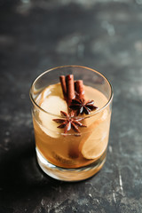 Healthy hot beverage with lemon, ginger and spices for protection in flu season. Selective focus. Shallow depth of field.