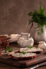 Black bread croutons with garlic and herbs with sauce on a wooden table