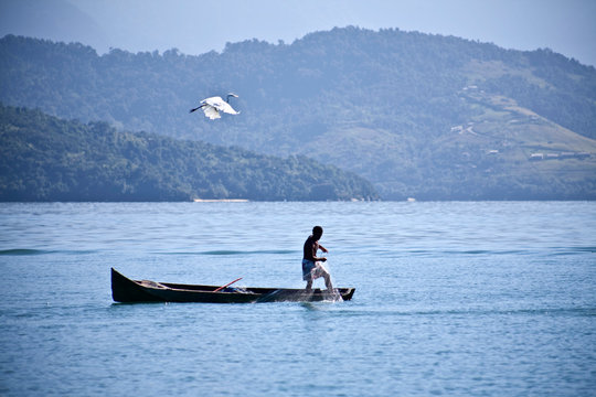 Lone fisherman in a canoe