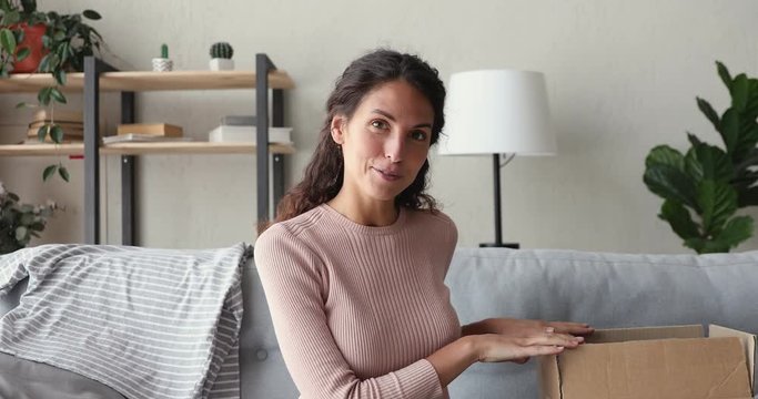 Happy girl fashion blogger shooting unboxing clothing video blog looking talking to camera at home. Social media influencer unpacking online store purchase delivery records vlog makes review. Cam view
