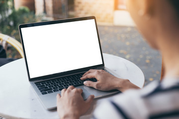 computer mockup image blank screen with white background for advertising text,hand woman using laptop contact business search information on desk at coffee shop.marketing and creative design