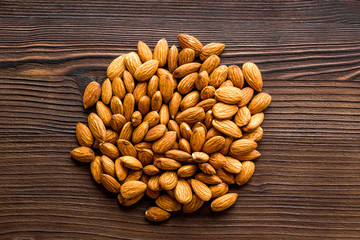 Almond kernels on wooden table top view
