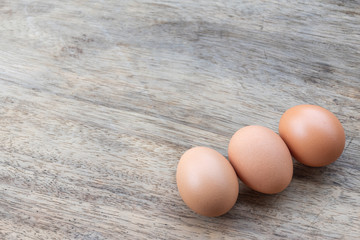 Close up chicken eggs on wooden table
