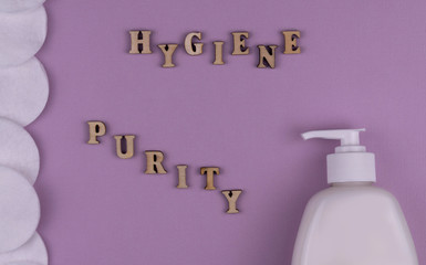 sanitizer gel and natural cotton sticks on purple background. stop the global epidemic of COVID-19.