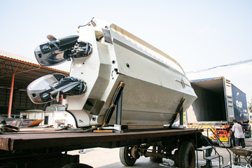 Fishing boat is pulling out from the truck container