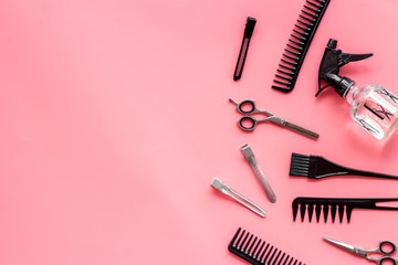 Beauty saloon accessories - combs, sciccors for hairdressing - on pink background top-down frame...