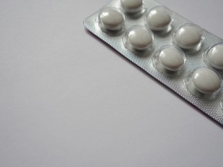 layout of tablets in plastic packaging on a light background