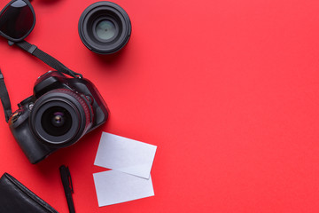 Modern photographer's equipment with cards on color background