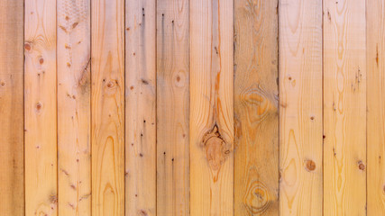 Plain fresh recycled wood background in panels, showing wood grain and nuts, with imperfections.  Copy space and slightly blurred background, with a rustic style. Wood has not been weathered.