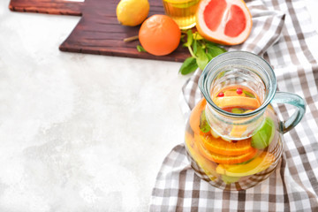 Jug of tasty cold tea on white background