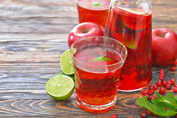 Glass of tasty cold tea on table