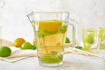 Jug of tasty cold tea on table