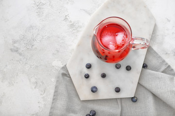 Obraz na płótnie Canvas Jug of tasty cold tea on white background