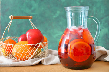 Jug of tasty cold tea on table