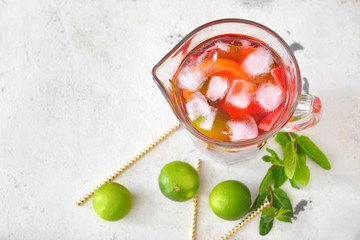 Jug of tasty cold tea on white background