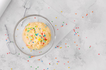 Bowl with sweet dough on table
