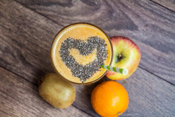 Orange Smoothie Juice with Apple and Orange and Chia Seeds in a Heart Shape . Healthy Life Concept.