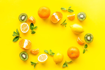 Colorful summer fruits frame on yellow background top view copy space