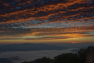 Fototapeta premium Twilight blue sky over a foggy valley in a morning