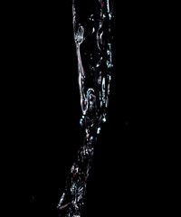 Water jet on a black background.