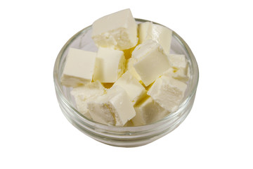 Feta cheese cubes in glass bowl isolated on white background